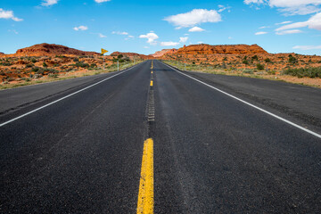 Fototapeta na wymiar Desert Drive: 4K Ultra HD Image of Desert Road and Red Rock in the USA