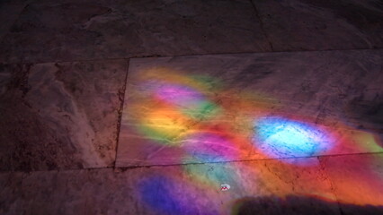 Colors from stained glass reflecting on the floor of the Mosque-Cathedral in Cordoba, Spain