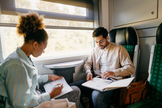 A man and a woman travel by train