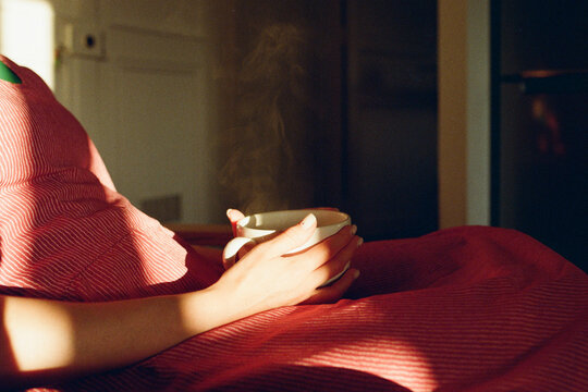 A woman with a cup of tea