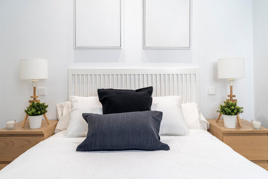 Modern and cozy bedroom with white and wooden decoration