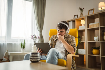 man caucasian male at home watch movie video online use digital tablet