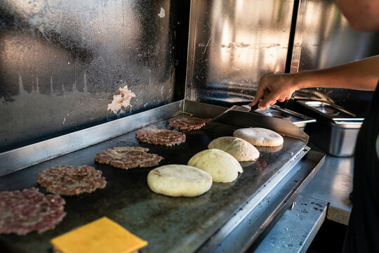 Cooking cheeseburgers in a food truck griddle