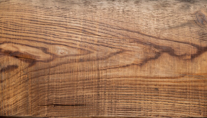 Fototapeta na wymiar Brown wood grain on a beautiful old plank.