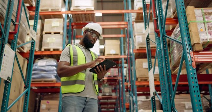 Warehouse, black man and manufacturing with tablet, boxes or inventory with digital app for logistics. African person, worker or employee with tech or inspection with checklist in a factory or import