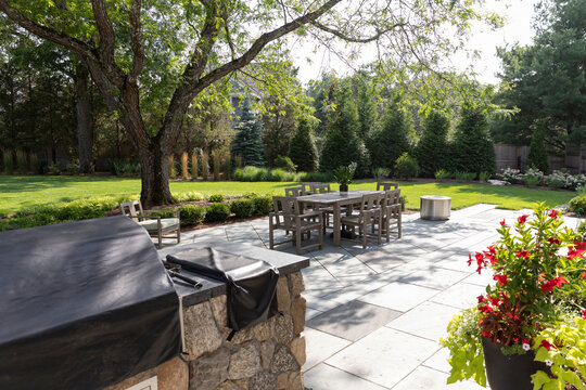 Summer Landscape backyard tile patio of Contemporary Home barbeque