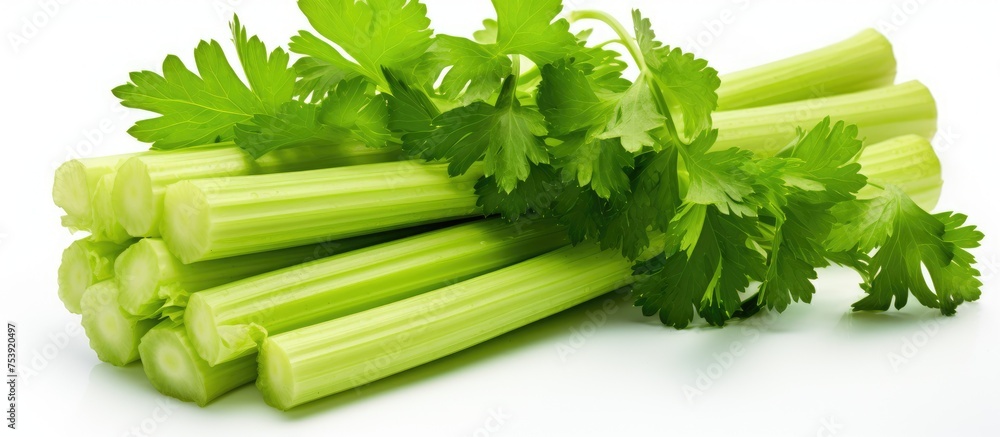 Poster a collection of fresh celery stalks arranged in a heap on a plain white surface. the green vegetable
