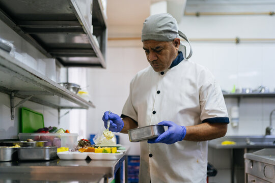 Chef adding causa to the plate