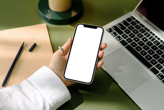 mock-up phone with a white screen. a woman holds a phone in her hand