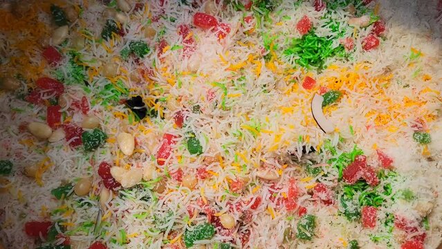 Degi mutanjan , sweet and colorful , Meethe chawal. Zardah Rice, Mutanjan rice, also known as sweet rice, favourite Indian sweet,saffron, cashew, cloves,dry fruits, yellow rice 4K Footage.
