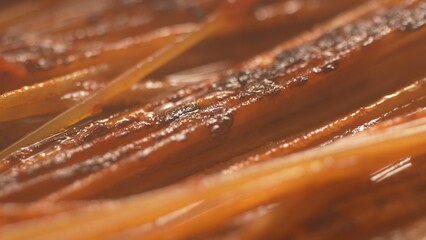 Close-up Frying Pasta with Tomato Sauce with steam. Step of Recipe Fried Assassin's Spaghetti Cooking.