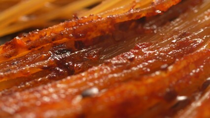 Close-up Sizzling in oil Pasta with Tomato Sauce. Step of Recipe Fried Assassin's Spaghetti Cooking.
