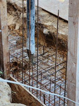Construction of building foundation. Pouring with liquid concrete of f