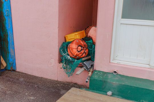 Various objects between pink buildings.