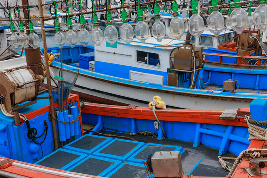 Blue fishing boats with various objects installed.