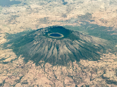 Aerial landscape view of Mount Zuqualla an extinct volcano in the Oromia Region of Ethiopia with an elliptical crater lake named Dembel in the center