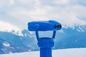 Binoculars on the mountain viewpoint at winter day. - 753932428