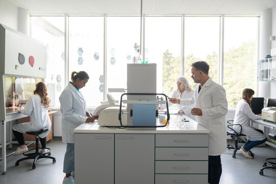 Many Scientists Working In Modern Laboratory