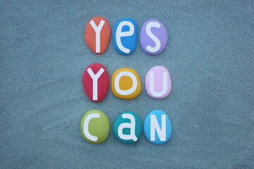 Yes, you can, creative and motivational slogan composed with hand painted multi colored stone...