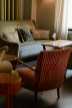 Blurred Armchairs and Sofa in Pastel Green Room