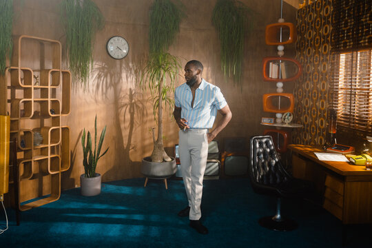 A man stands in a retro office