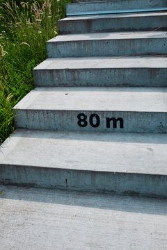 Concrete stairs with number symbol typographic mark "80 meters"