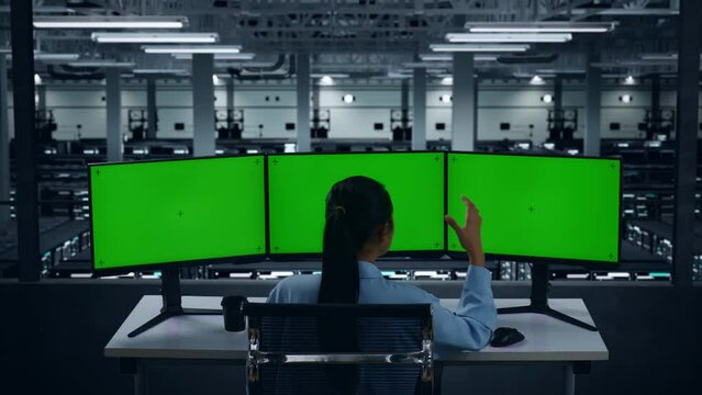 Back View Of Asian Woman Having Headache While Working With Mock Up Multiple Computer Monitor In Data Center