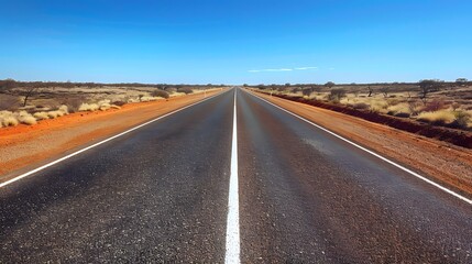 Fototapeta na wymiar Straight road with white lines in middle of outback red centre Australia