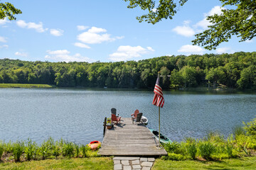 photo of a dock at a lake, lakeside in a northeastern setting, summer landscape