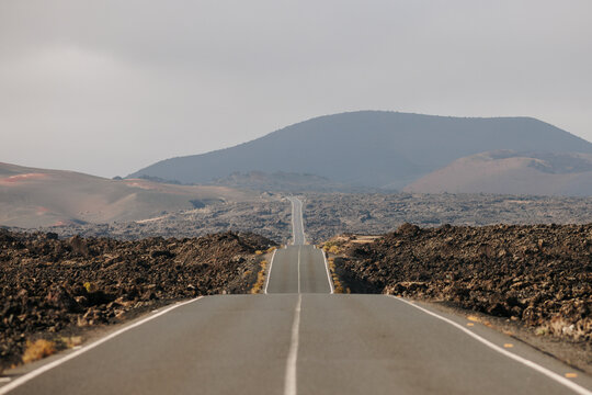 Long and lonely straight road with ascents and descents
