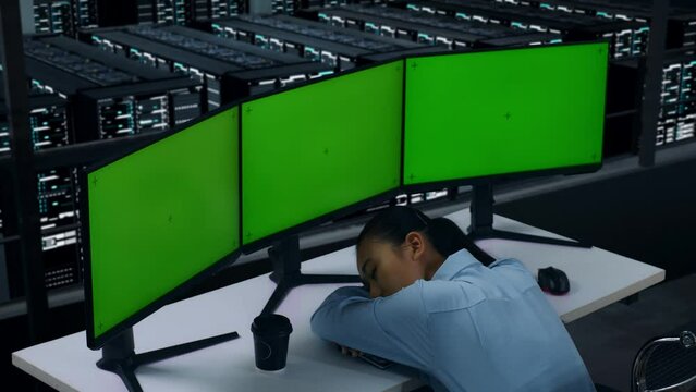 Side View Of Tired Asian Woman Sleeping While Working With Mock Up Multiple Computer Monitor In Data Center