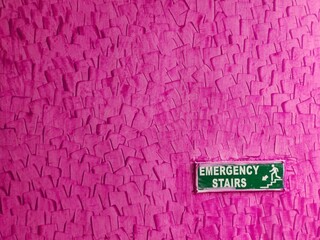 Emergency stair written on the wall of a building for escaping
