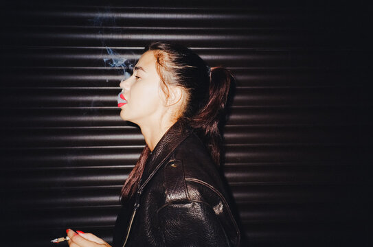 Smoking cigarette at night 