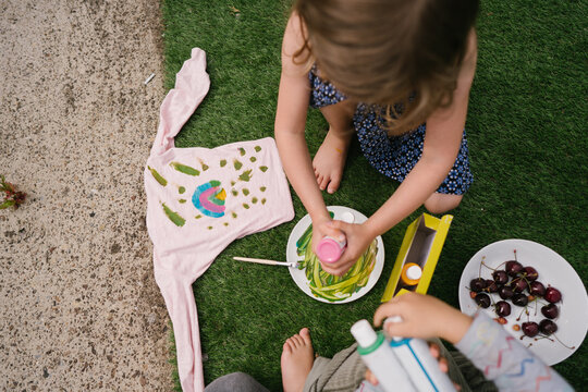 Children draw with paints outdoors
