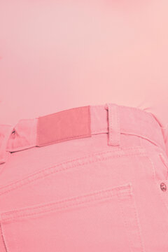 Close-up of person wearing pink jeans and pink top