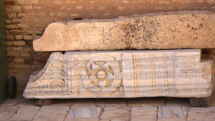 Roman carved stone lying in the courtyard of the Great Mosque of Kairouan, in Kairouan, Tunisia