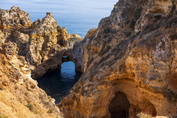 Fototapeta na wymiar Rock arch in water, Ponta da Piedade rock formations. Travel destination in Europe. Ponta da Piedade in Lagos, Algarve, Portugal