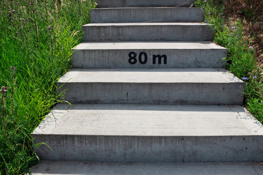 Concrete stairs with number symbol typographic mark "80 meters"