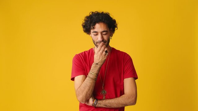 Upset man showing disagreement isolated on yellow background