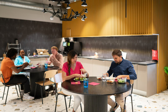 People Having Lunch At Office Kitchen