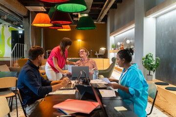 Coworkers Working Together At Cozy Office