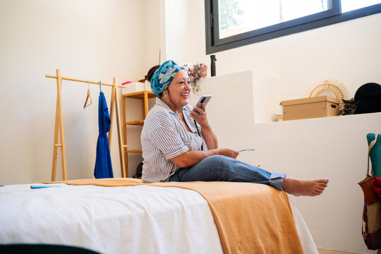 Mature Plus-Size Woman Relaxing and Smiling While Talking on Phone fro
