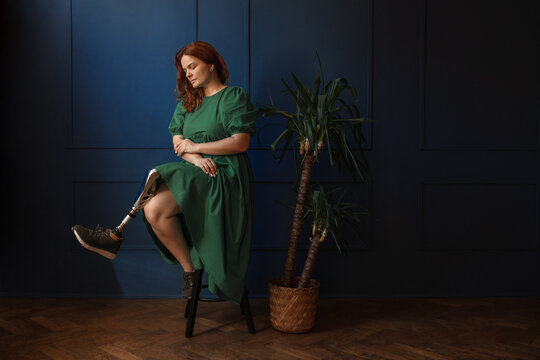 Dramatic portrait of a disabled woman with a prosthetic leg