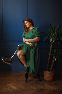 Portrait of a thoughtful disabled woman with a prosthetic leg