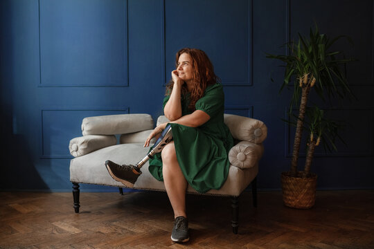 Portrait of a cheerful disabled woman with a prosthetic leg 