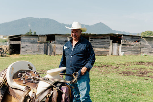 Farmer observing a horse saddle.