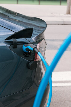 Electric car with charger plugged in