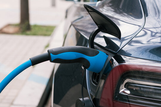 Electric car with charger plugged in