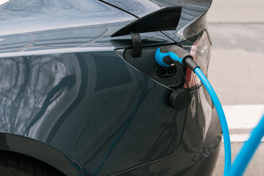 Electric car with charger plugged in