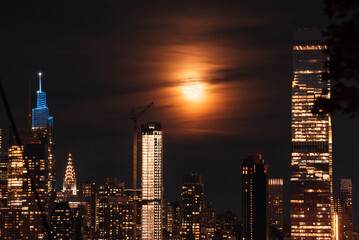 Glimpse of Uptown Manhattan: Full moon gracing the iconic skyline with